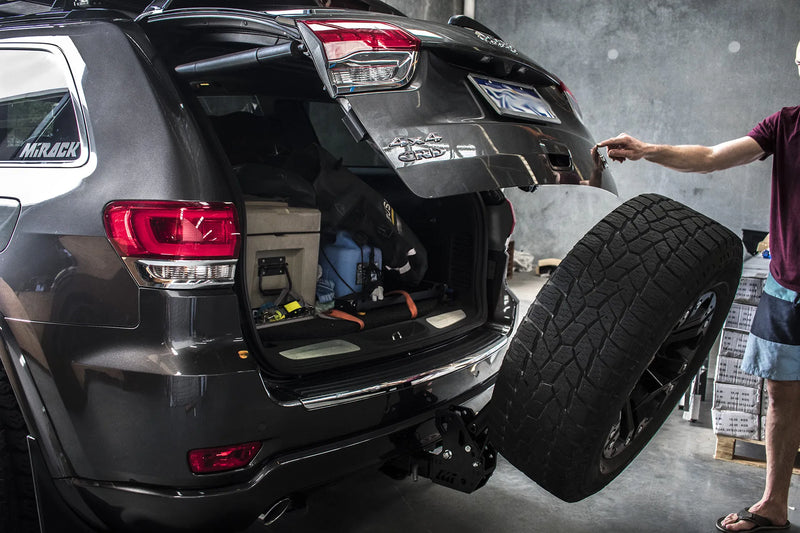 Load image into Gallery viewer, Jeep Grand Cherokee ready for adventure: Spare wheel out of the way, Mirack on tow hitch (boot open).