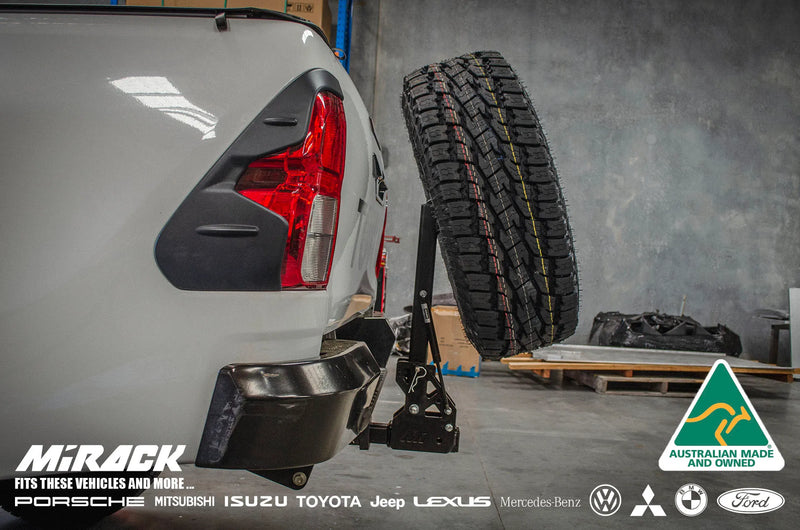 Load image into Gallery viewer, Easy rear access & off-road freedom: Hilux SR5 upgraded with Mirack's tilting spare wheel carrier.